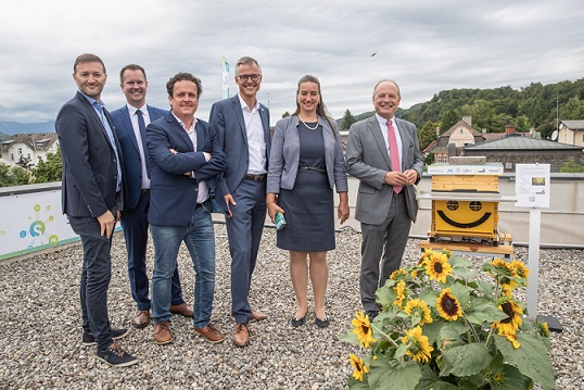 Representatives stand next to the 5G Bee-O-Meter